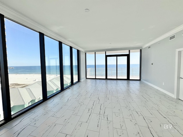 unfurnished room with visible vents, a water view, ornamental molding, expansive windows, and baseboards