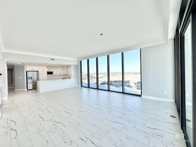 unfurnished living room with visible vents, marble finish floor, ornamental molding, a wall of windows, and baseboards