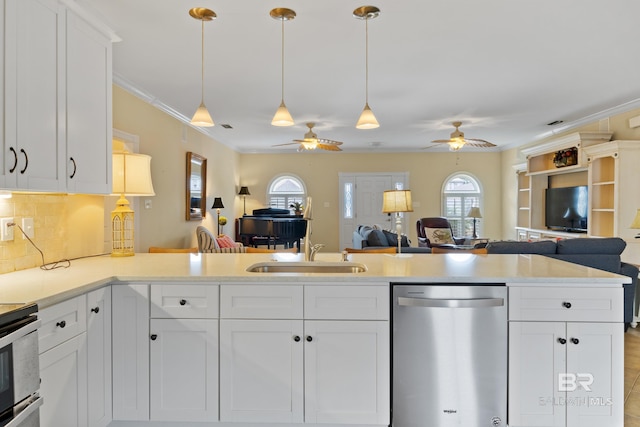 kitchen featuring appliances with stainless steel finishes, sink, white cabinets, backsplash, and crown molding