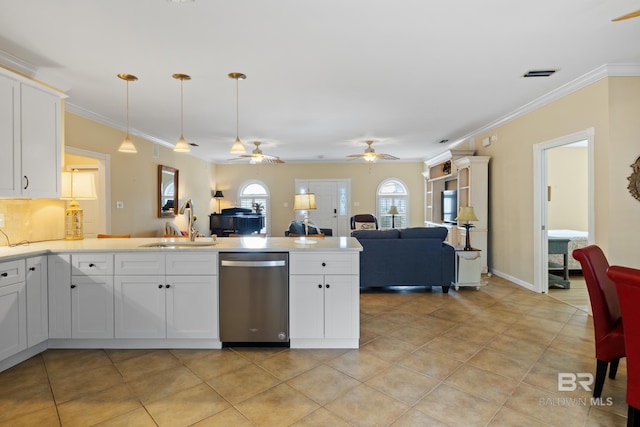 kitchen featuring white cabinetry, sink, hanging light fixtures, stainless steel dishwasher, and light tile patterned floors