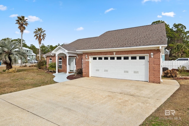 view of front of house featuring a garage and a front lawn