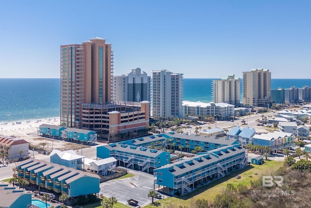 drone / aerial view featuring a water view and a view of city