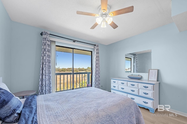 bedroom featuring access to exterior, light wood finished floors, baseboards, a textured ceiling, and a ceiling fan