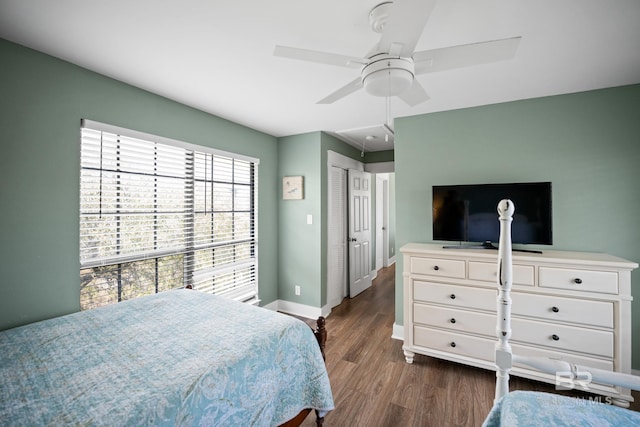 bedroom with attic access, dark wood finished floors, baseboards, and ceiling fan