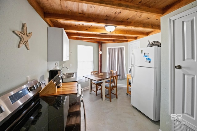kitchen with freestanding refrigerator, stainless steel range with electric stovetop, a sink, wooden ceiling, and concrete floors