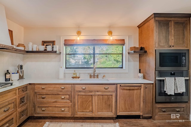 kitchen featuring sink, tasteful backsplash, black microwave, dishwasher, and oven