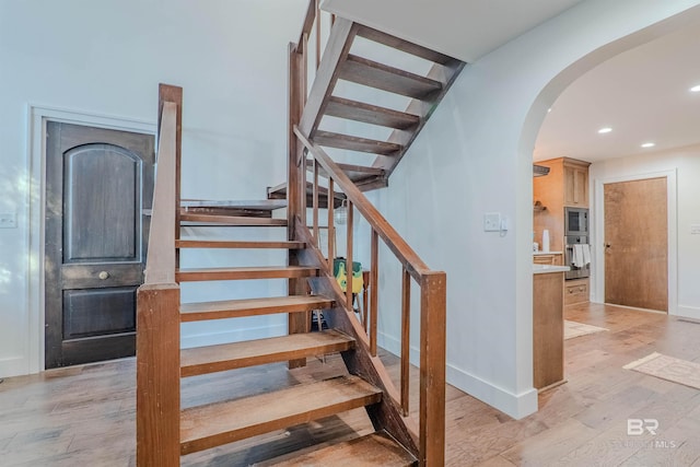 stairway featuring hardwood / wood-style flooring