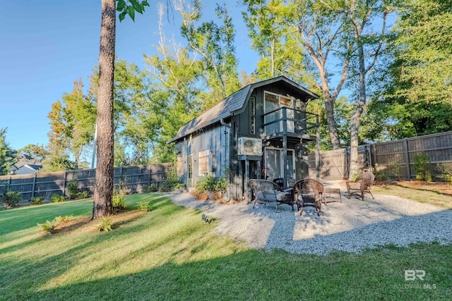 view of outdoor structure featuring an outdoor fire pit and a lawn