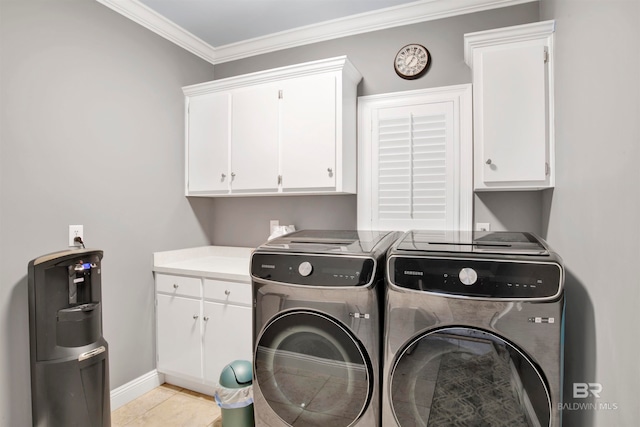 laundry area with light tile patterned floors, separate washer and dryer, cabinets, and ornamental molding