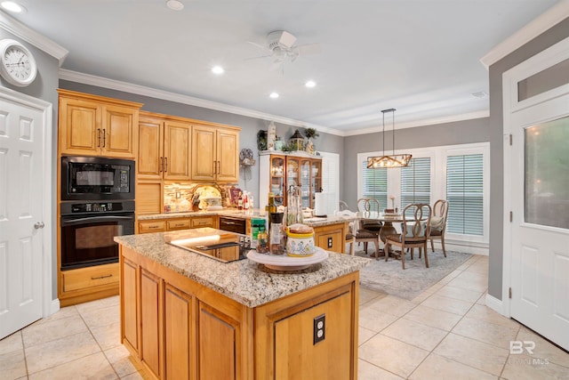 kitchen with light stone counters, ceiling fan with notable chandelier, a kitchen island, black appliances, and crown molding