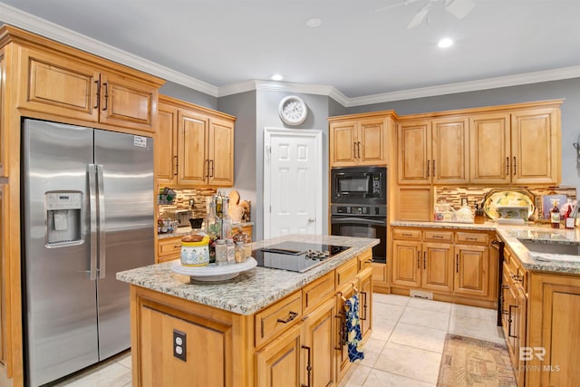 kitchen with tasteful backsplash, light tile patterned floors, black appliances, crown molding, and a center island