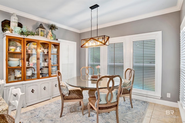 tiled dining space with crown molding and a notable chandelier