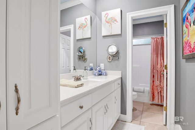 full bathroom with shower / tub combo with curtain, vanity, toilet, and tile patterned floors