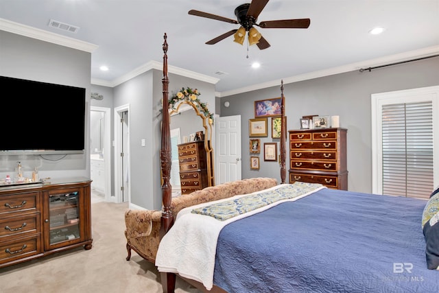 carpeted bedroom featuring ceiling fan, ensuite bath, and ornamental molding