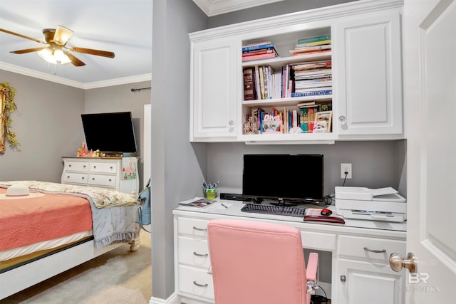 bedroom with built in desk, ornamental molding, light carpet, and ceiling fan