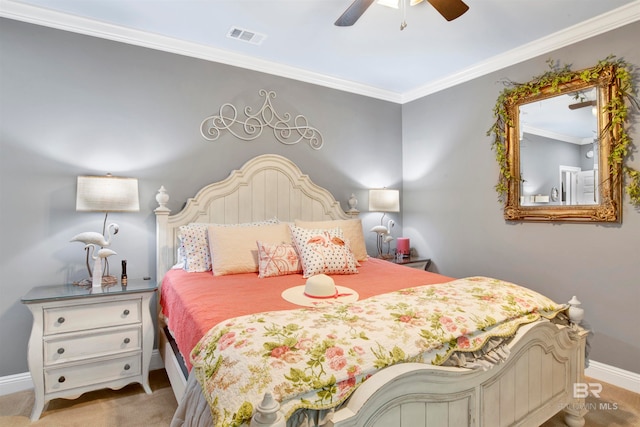 carpeted bedroom with ceiling fan and ornamental molding