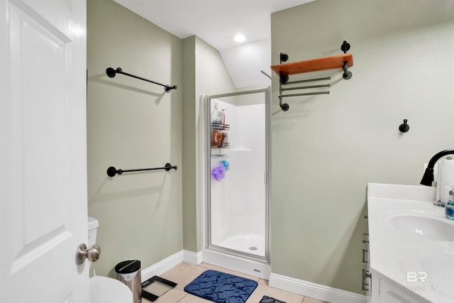 bathroom featuring vaulted ceiling, vanity, tile patterned flooring, a shower with door, and toilet