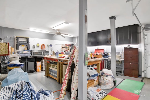 miscellaneous room featuring ceiling fan and a workshop area