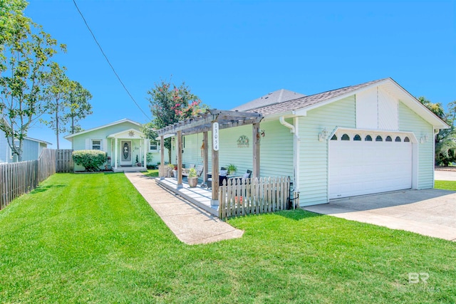 rear view of house featuring a lawn, a garage, and a pergola