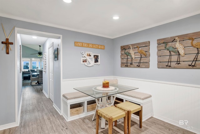 dining space featuring light wood-type flooring, crown molding, and ceiling fan