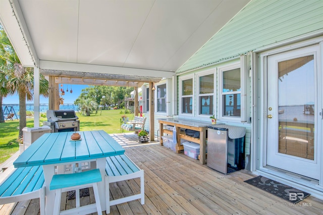 wooden deck with a grill and a yard