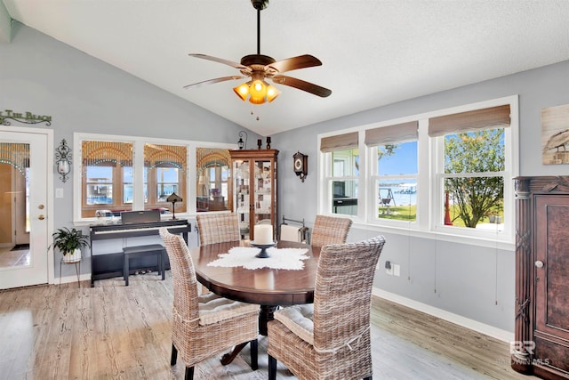 dining area with light hardwood / wood-style flooring, vaulted ceiling, and ceiling fan