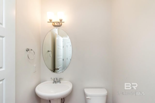 bathroom featuring sink and toilet