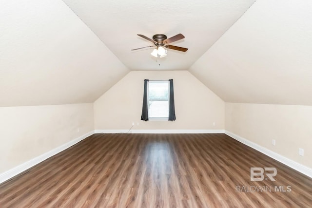 additional living space with ceiling fan, lofted ceiling, and hardwood / wood-style flooring