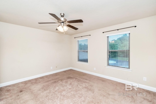 empty room featuring ceiling fan and light carpet