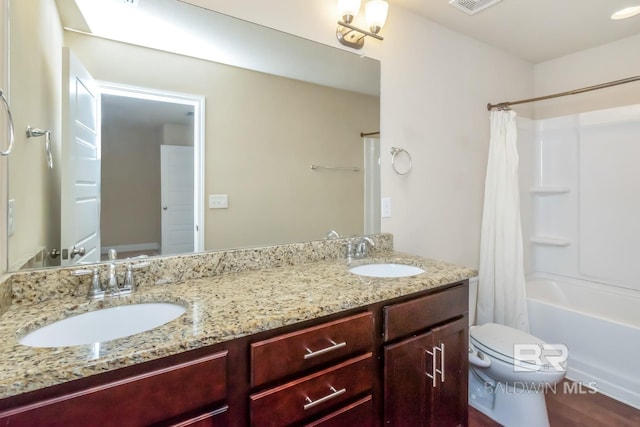 full bathroom featuring toilet, hardwood / wood-style floors, vanity, and shower / bathtub combination with curtain