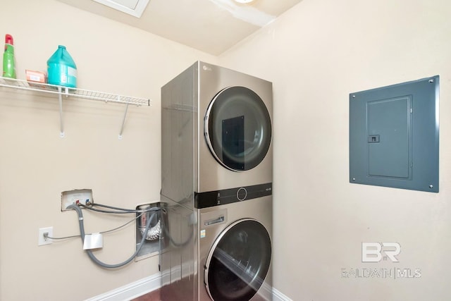 washroom featuring stacked washer / dryer and electric panel