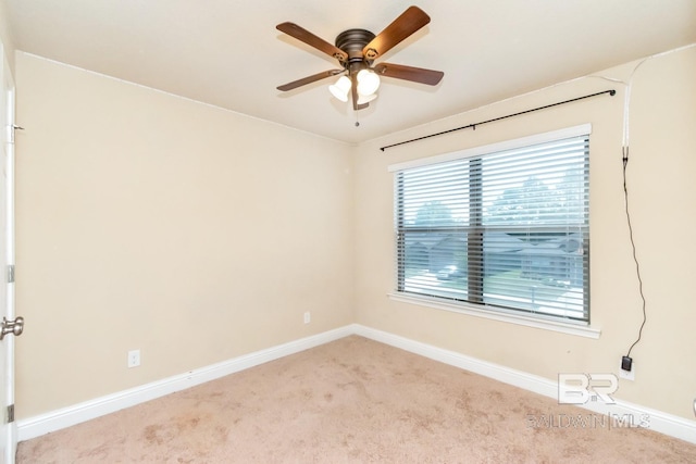 carpeted empty room featuring ceiling fan