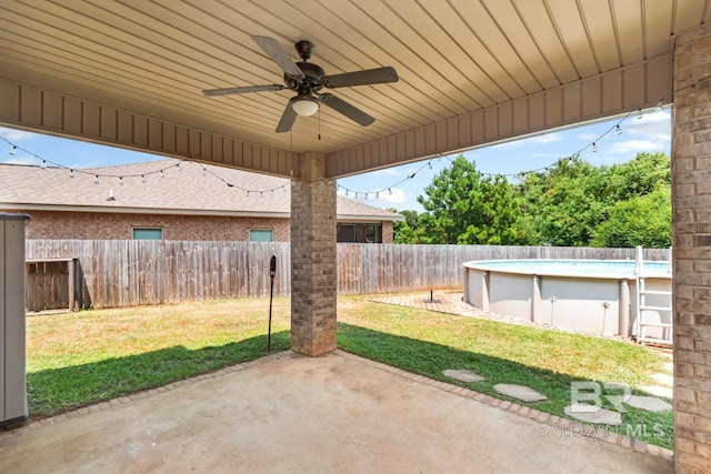 view of patio / terrace with ceiling fan and a fenced in pool