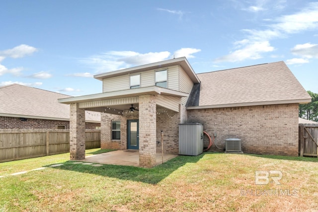 back of property featuring ceiling fan, a patio, central AC, and a yard