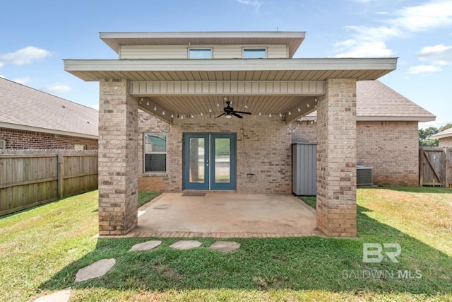 back of property featuring ceiling fan, central AC, a patio area, and a lawn