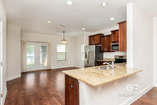 kitchen featuring sink, dark wood-type flooring, french doors, light stone countertops, and stainless steel appliances