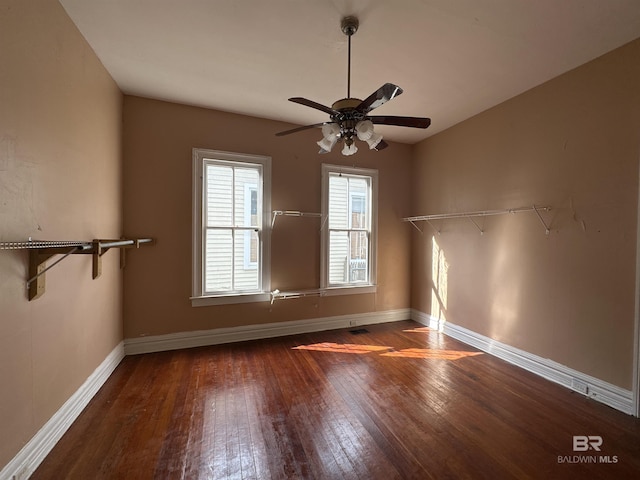 spare room featuring dark hardwood / wood-style floors and ceiling fan