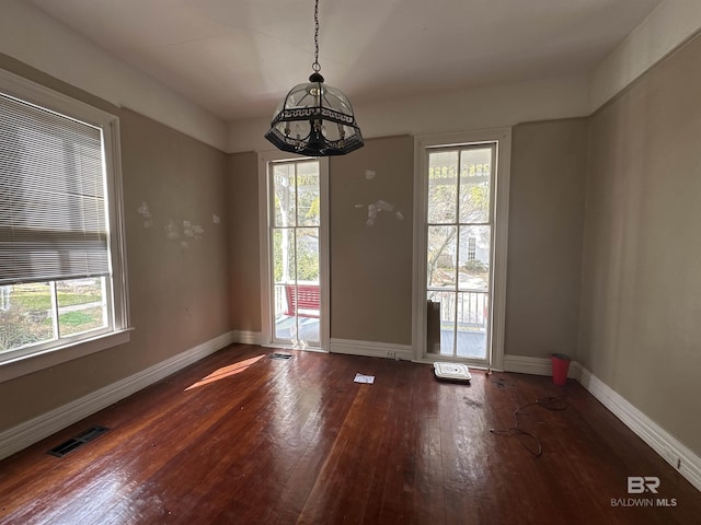 unfurnished dining area with a healthy amount of sunlight and wood-type flooring