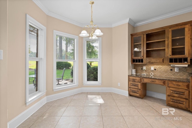 9529 Aspen Cir, Daphne, AL 36527 - unfurnished dining area with crown molding, baseboards, light tile patterned flooring, and a chandelier