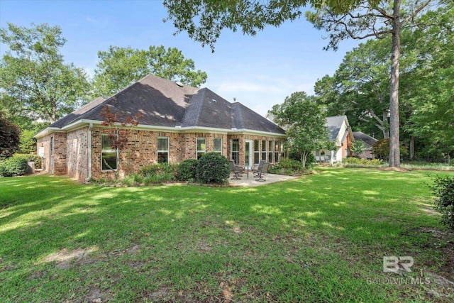 9529 Aspen Cir, Daphne, AL 36527 - rear view of property with a patio area, brick siding, and a yard