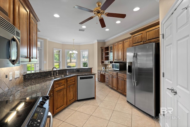 9529 Aspen Cir, Daphne, AL 36527 - kitchen featuring appliances with stainless steel finishes, a sink, brown cabinets, tasteful backsplash, and light tile patterned flooring