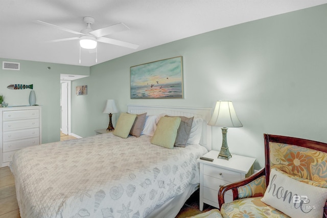 tiled bedroom featuring ceiling fan