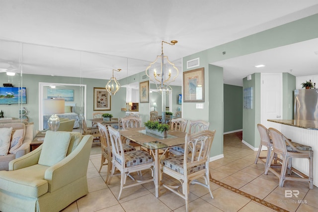 tiled dining room featuring a notable chandelier