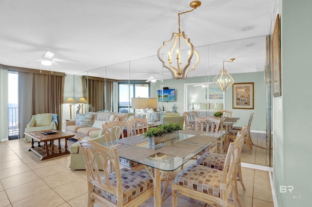 tiled dining room featuring ceiling fan with notable chandelier