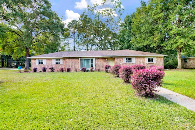 ranch-style home with a front lawn