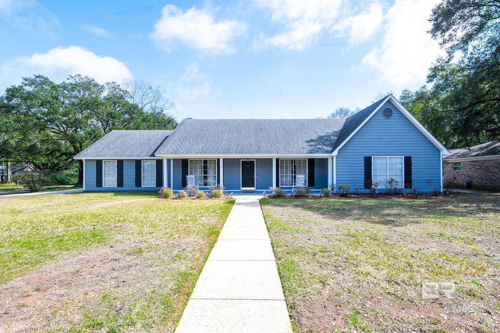 single story home with a porch, roof with shingles, and a front lawn