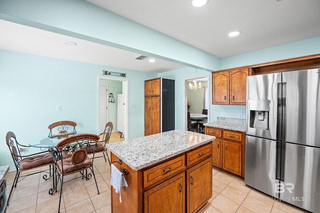 2553 Santa Rosa Dr, Lillian, AL 36549 - kitchen with stainless steel refrigerator with ice dispenser, brown cabinets, a chandelier, light tile patterned floors, and recessed lighting