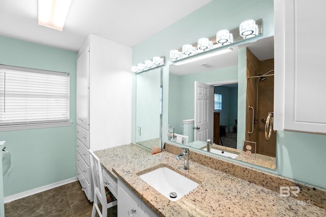 2553 Santa Rosa Dr, Lillian, AL 36549 - full bathroom with vanity, toilet, baseboards, and a shower