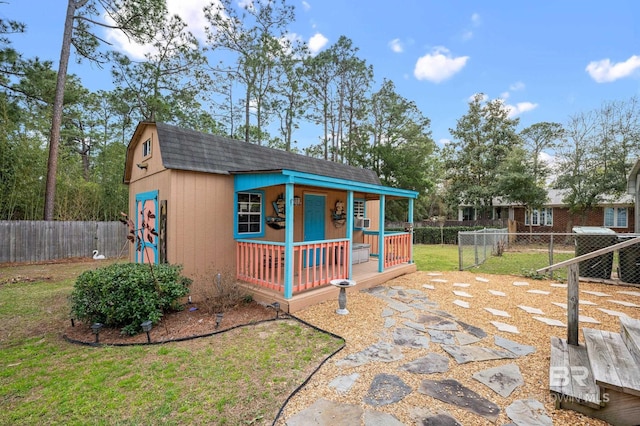 2553 Santa Rosa Dr, Lillian, AL 36549 - view of front facade with a shingled roof, an outbuilding, and a gambrel roof