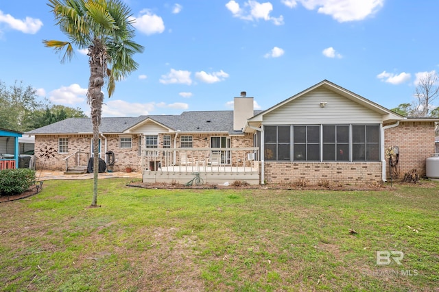 2553 Santa Rosa Dr, Lillian, AL 36549 - rear view of property featuring brick siding, a sunroom, a chimney, a lawn, and a deck